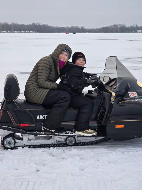 Steph Riding a Snowmobile on the Lake with Our Nephew