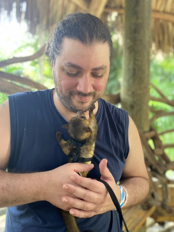 Kris Carrying a Baby Kinkajou at an Exotic Animal Rescue Facility
